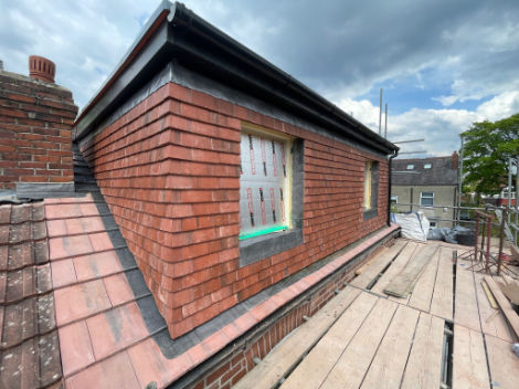 An image showing an dormer roof being built